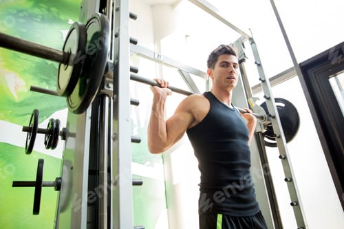 Preview: Handsome man training in gym