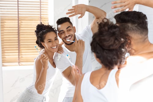 Preview: Morning Hygiene. Joyful Middle Eastern Couple Brushing Teeth And Dancing In Bathroom