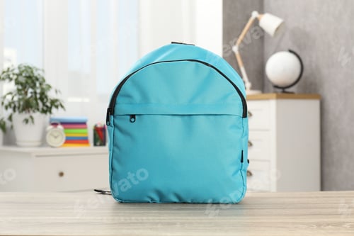 Preview: Light blue backpack on desk in room
