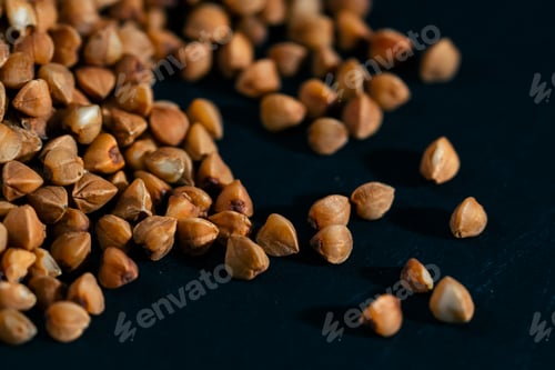 Preview: close up buckwheat lies on a black and blue background Ukrainian culture light protein food