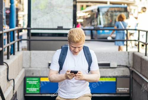 Preview: Young albino man using smartphone in the city