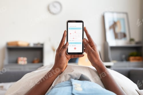 Preview: African-American Woman Planning Day via Smartphone App