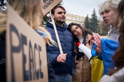 Preview: Worried young caucasian people on manifestation against Ukrainian war outdoors