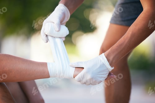 Preview: First aid, sports injury and bandage on wrist, man in park gets help from medic for injury in outdo