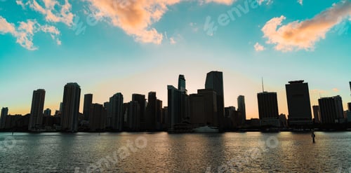 Preview: Skyline of a bustling city with its towering buildings overlooking a vast body of water
