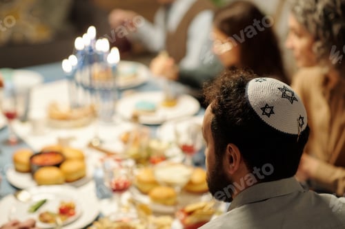 Preview: Side view of head of mature bearded man in yarmulke with stars of David