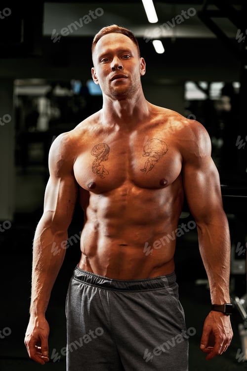 Preview: Closeup portrait of a muscular man workout with barbell at gym. Brutal bodybuilder athletic man with