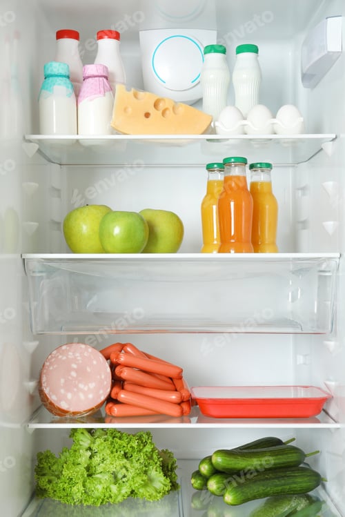 Preview: Open refrigerator with many different products, closeup