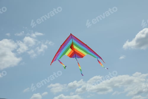 Preview: Colorful kite flying in blue sky, low angle view