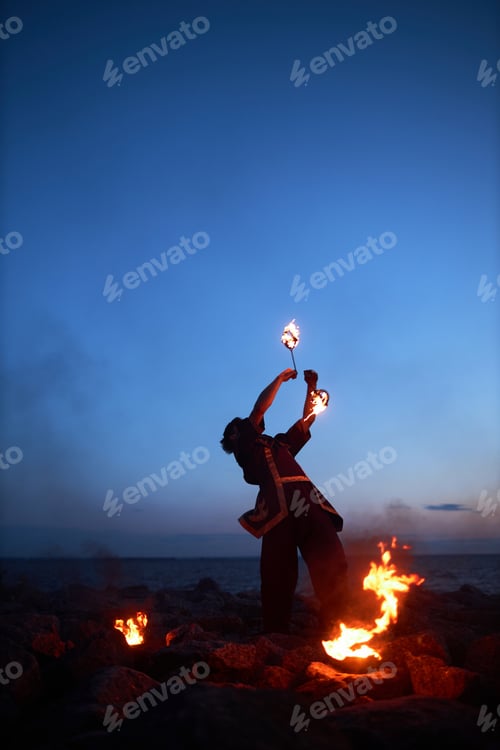 Preview: Man Doing Tribal Dance with Fire on Night Sky