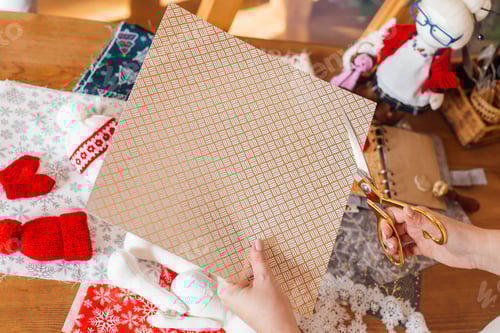 Preview: female hands cuts paper for scrapbooking, handmade postcard on background of colorful paper