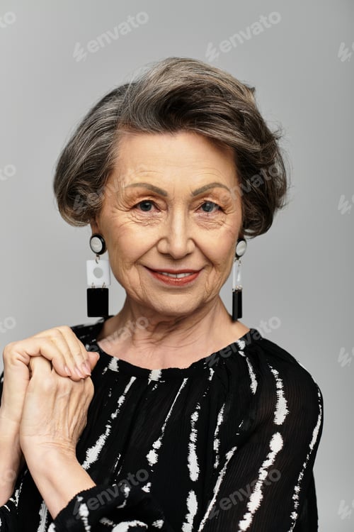 Preview: A beautiful woman in her 60s radiates elegance while posing gracefully in trendy attire.