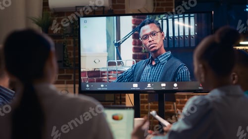 Preview: African american remote team leader speaking in videocall