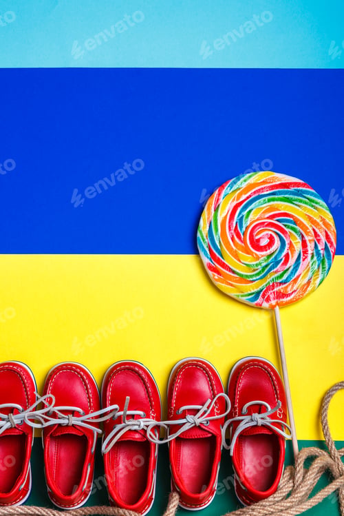 Preview: Small red boat shoes near big multi-colored lollipop