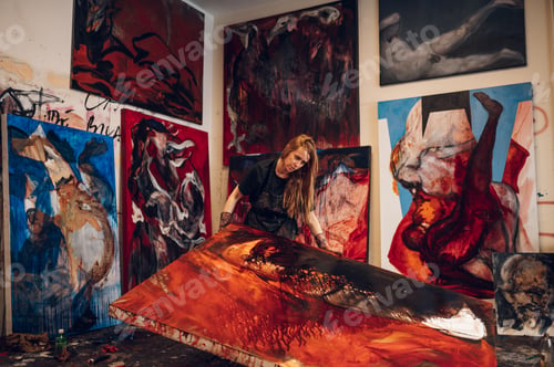 Preview: Female painter artist painting and creating her art in a creative studio