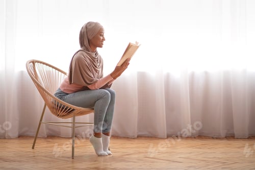 Preview: Woman Relaxing in a Chair Reading a Book