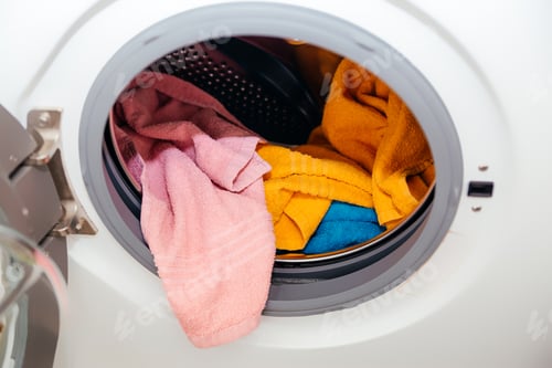 Preview: Colored towels in an open washing machine.