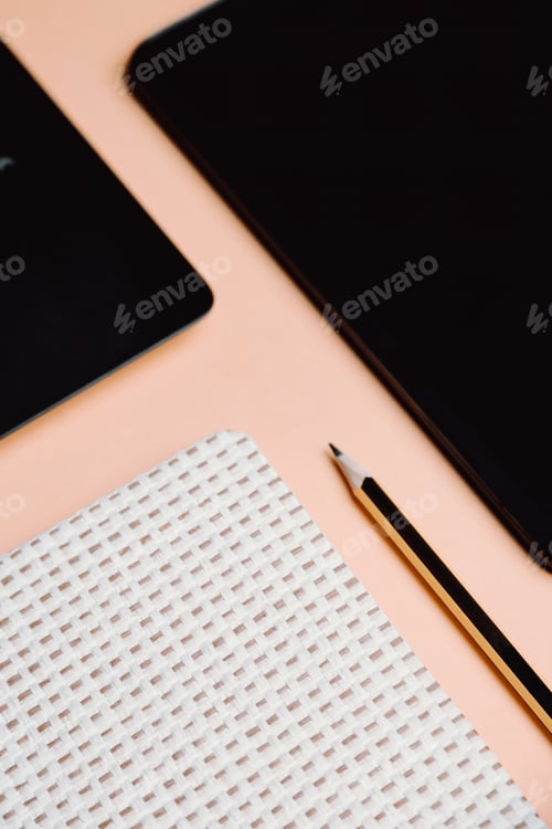Preview: Blank notepad is on top of color office desk table with laptop computer, phone