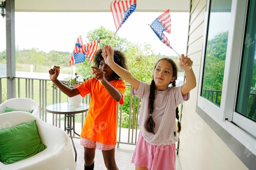 Preview: Children celebrate outdoors with American flags on a sunny day