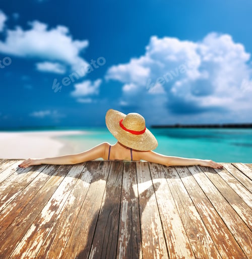 Preview: Woman In Hat Relaxing At Beach Jetty