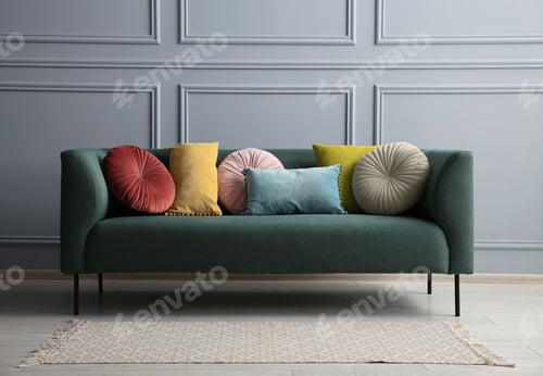 Preview: Stylish sofa with different cushions near grey wall