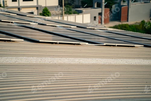 Preview: Solar panel installer installing solar panels on roof of warehouse