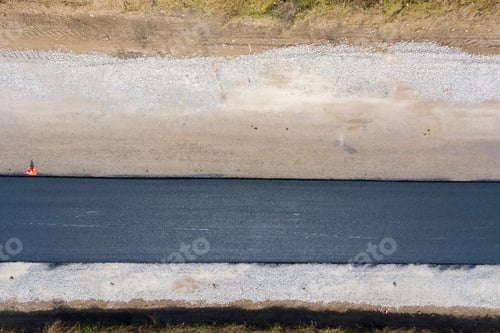 Preview: Aerial view of new road construction with newly layed black asphalt lane.