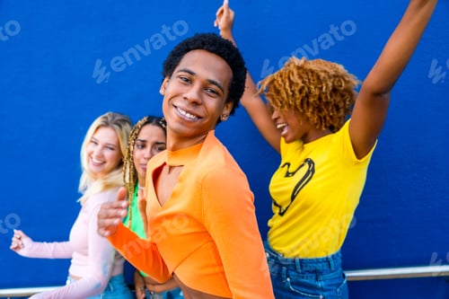 Preview: Transgender person and young people dancing happily outdoors