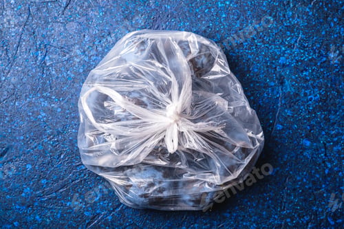 Preview: Fresh ripe plum fruits in plastic bag package on blue abstract background