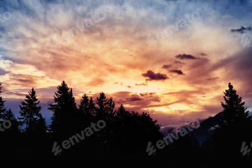 Preview: Fantastic sunset over the forest and mountains