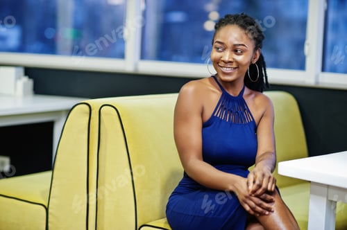 Preview: African woman in dress posing at restaurant
