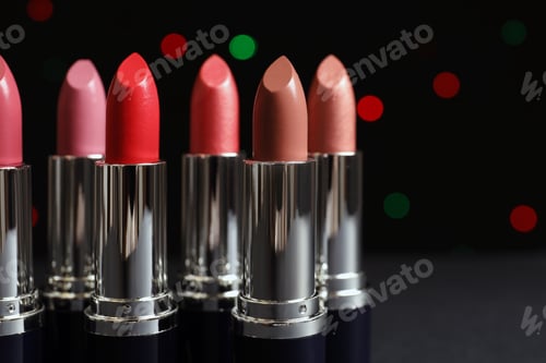 Preview: Different lipsticks against blurred lights. Cosmetic product