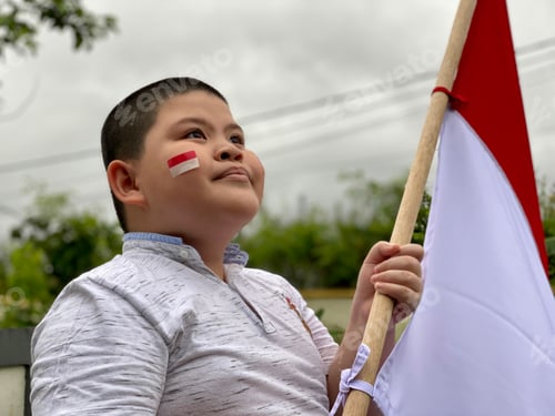 Preview: Child Celebrates with National Flag in Urban Setting