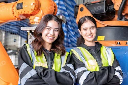 Preview: Women engineer team together at work in modern advanced robot welding machine sell service factory
