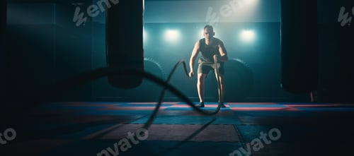 Preview: Fitness athlete training using battle ropes intense workout