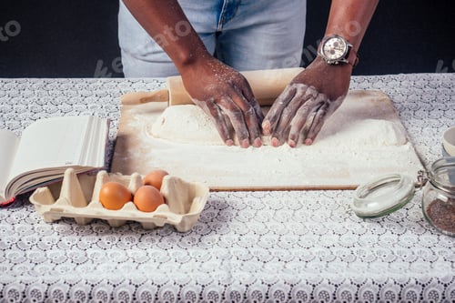 Preview: African American male cook chef boasts of pastry hands in flour baking