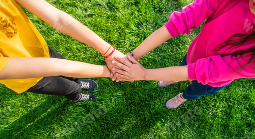 Preview: Children walk together holding hands. Selective focus.