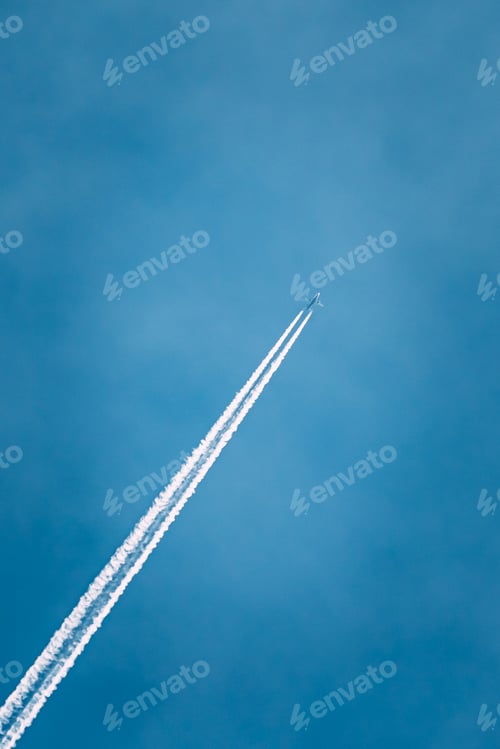 Preview: Contrail In Blue Sky. Plane In Sunny Sky Background. Airplane Aircraft In Sky With Trails