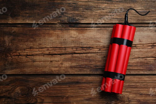 Preview: Red explosive dynamite bomb on wooden background, top view. Space for text