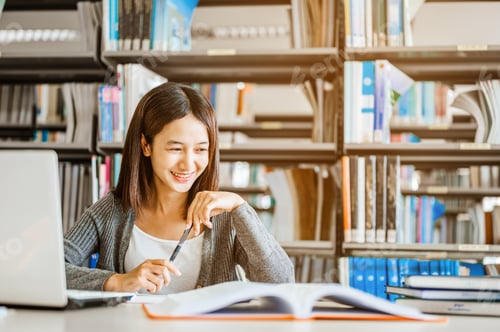 Preview: High school or college students studying and reading together in library. Student use laptop at libr