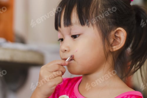 Preview: An Asian child girl make up on her face. Beautiful kids