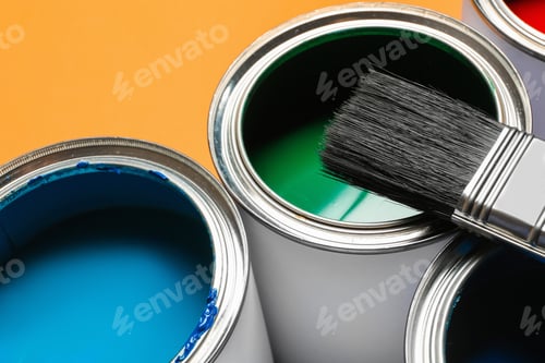 Preview: Closeup view of paint cans and brush on color background