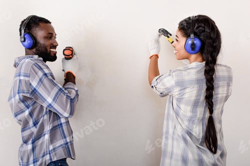 Preview: couple making renovation of home with drill and hammer together