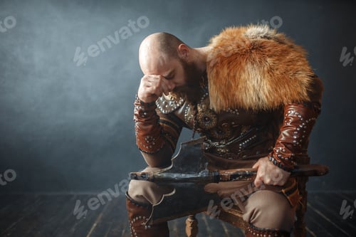 Preview: Sad viking with axe sitting on chair