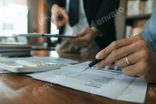 Preview: Business partnership pointing to the graph of the company financial statements report and profits ea