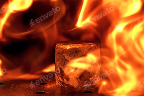 Preview: Close up big melting piece of ice on the bar counter in fireflames on it, preparation for a cocktail