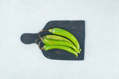 Preview: Green chili peppers on dark board