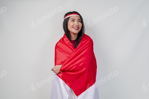 Preview: Smiling young Asian woman with Indonesian flag draped over her shoulders.