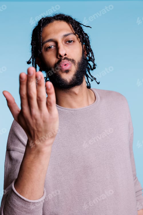 Preview: Attractive arab man blowing flirty air kiss