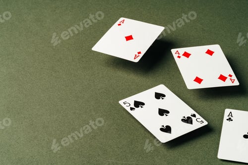 Preview: Playing cards on green background studio shot